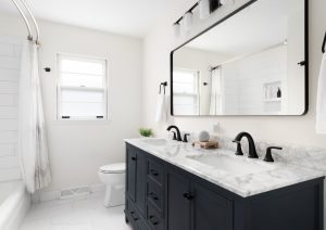 A,Beautiful,Bathroom,With,A,Dark,Blue,Vanity,Cabinet,,Marble